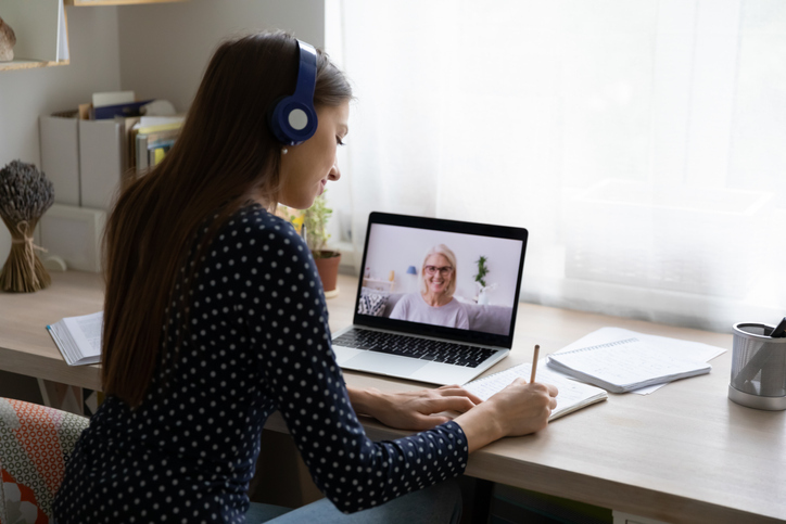 Female employee watching online cybersecurity trainings on a laptop.