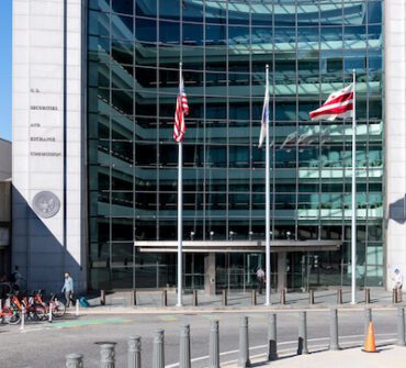 US United States Securities and Exchange Commission SEC architecture by empty street road with modern building sign and logo with flag glass windows