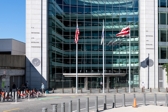 US United States Securities and Exchange Commission SEC architecture by empty street road with modern building sign and logo with flag glass windows