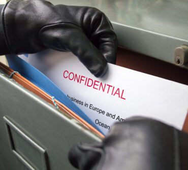 thief stealing confidential files in an office and performing corporate espionage